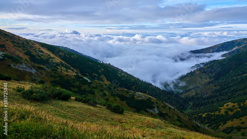 Beautiful view on clouds rolling over mountain ridges, Low Tatras, Slovakia.