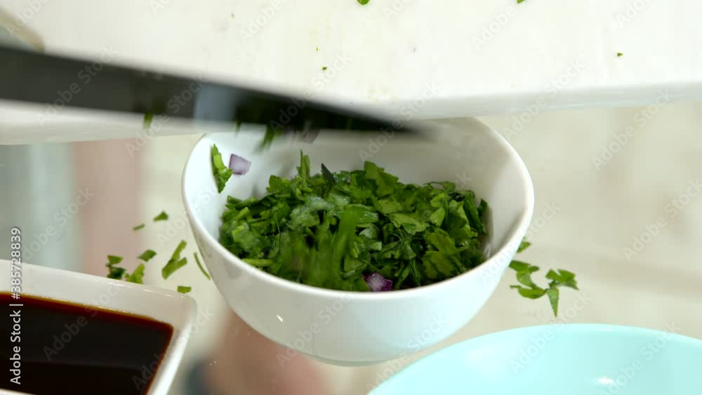 chef adds chopped parsley to white bowl of sliced onions cooking japanese food at home on glass table. Vegetarian, vegan cuisine concept. Cooking tutorial. Beginner Cook's Blog chef adds chopped parsley to white bowl of sliced onions cooking japanese food at home on glass table. Vegetarian, vegan cuisine concept. Cooking tutorial. Beginner Cook's Blog