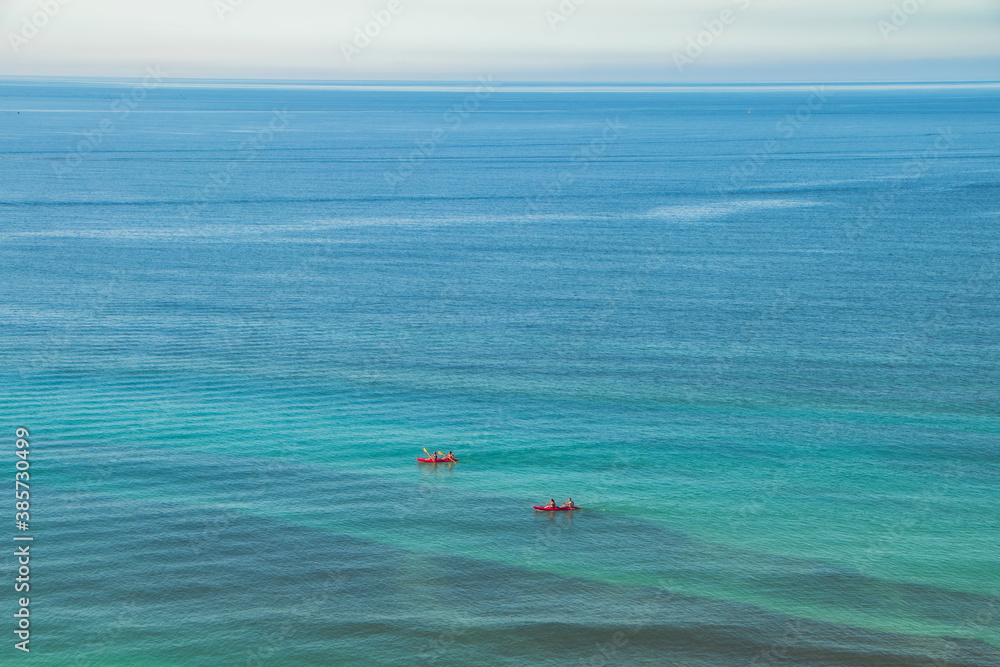 Kayaks with a beautiful seascape behind Kayaks with a beautiful seascape behind