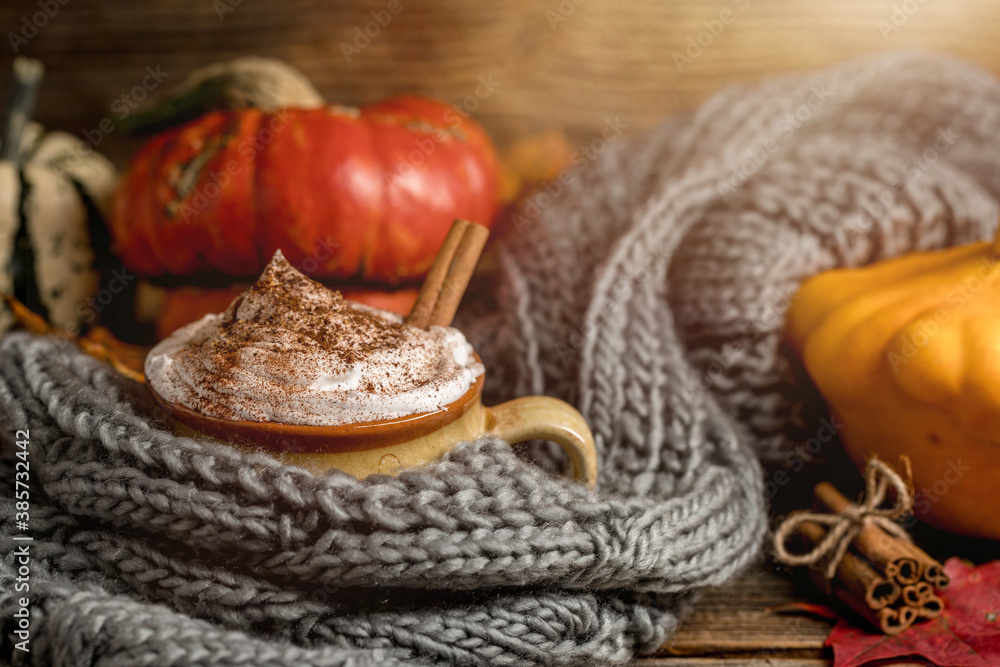 Autumn concept, still life of pumpkin spice latte with whipped milk cream and cinamon. Colorful pumpkins and dry leaves. Old natural wood backround Autumn concept, still life of pumpkin spice latte with whipped milk cream and cinamon. Colorful pumpkins and dry leaves. Old natural wood backround