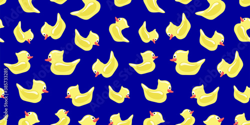 Seamless pattern with yellow toy ducks on a blue background.