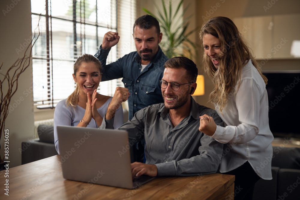 Obraz premium Authentic shot of young successful people are controlling emails on laptop exulting and celebrating an approved and promotion of new project in in creative agency office.