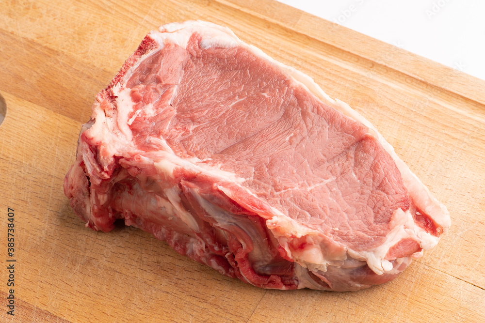 Piece of fresh beef meat on cutting board Piece of fresh beef meat on cutting board