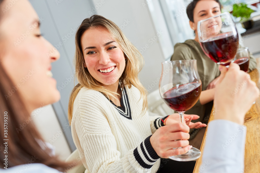 Group of women talking as friends over glass of red wine Group of women talking as friends over glass of red wine