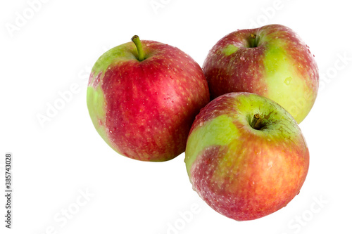 Three fresh juicy ripe apples on an isolated white background.