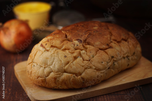 Whole wheat onion bread on wooden chop. Nutrition fact and clean food good taste ideas concept. Selective focus and free space for text.