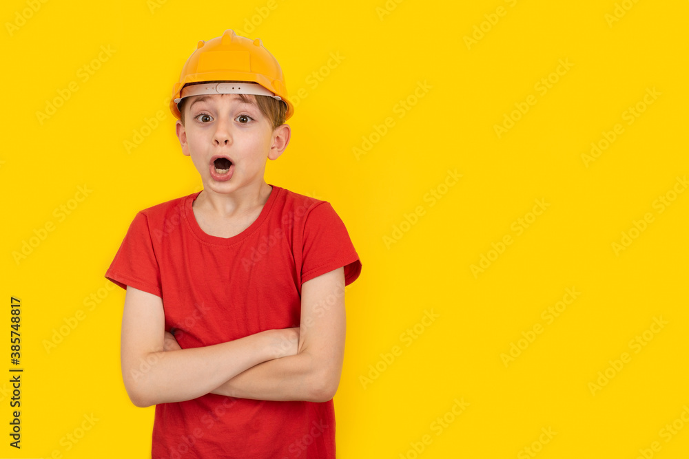 Surprised guy in hardhat on yellow background. Choice of future profession. Copy space, Surprised guy in hardhat on yellow background. Choice of future profession. Copy space,