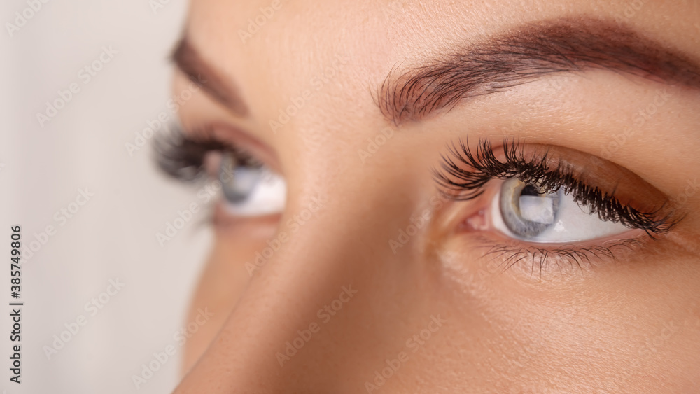 Eyelash Extension Procedure. Woman Eye with Long Eyelashes. Close up, selective focus. Eyelash Extension Procedure. Woman Eye with Long Eyelashes. Close up, selective focus.