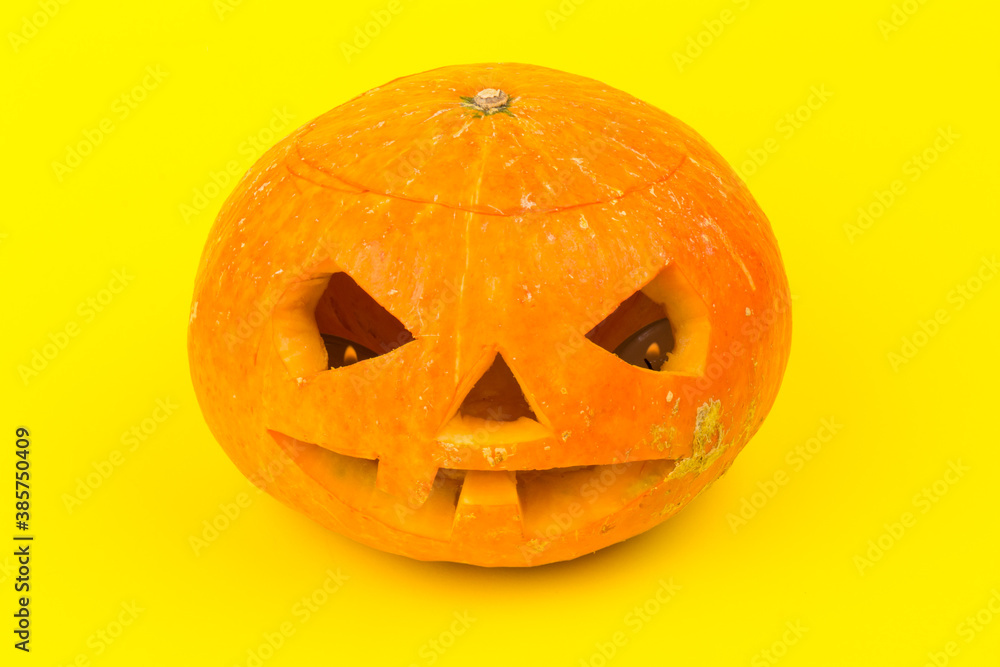 Glowing Halloween Pumpkin isolated on yellow background Glowing Halloween Pumpkin isolated on yellow background