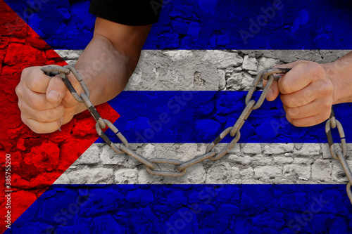 Fotografie male hands breaking the iron chain, symbol of tyranny, protest against the backg