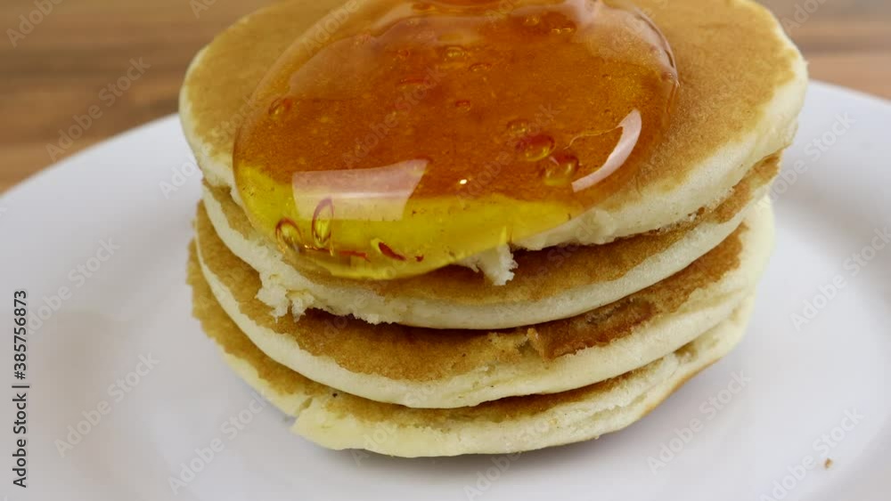 Close Up Of Syrup Being Poured Onto Pancakes Close Up Of Syrup Being Poured Onto Pancakes