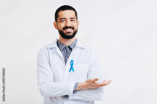 Prostate Cancer Awareness. Doctor man holding light Blue Ribbon for supporting people living and illness. Men Healthcare and World cancer day concept