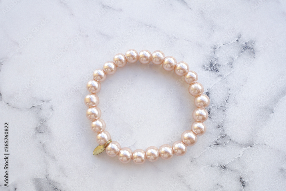 Pink pearl bracelet is on the table, women's jewelry on the hand Pink pearl bracelet is on the table, women's jewelry on the hand