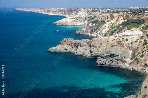 Mountain in the form of a dolphin on the black sea in Crimea. Cape Kapchik in the Black Sea near the village of Novy Svet sunny summer day. Natural colors and light, summer nature background concept.