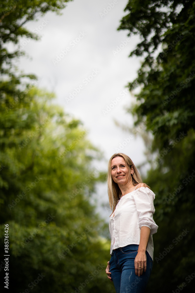 Portrait of a relaxed middle aged woman outdoors, looking happy, enjoying the life