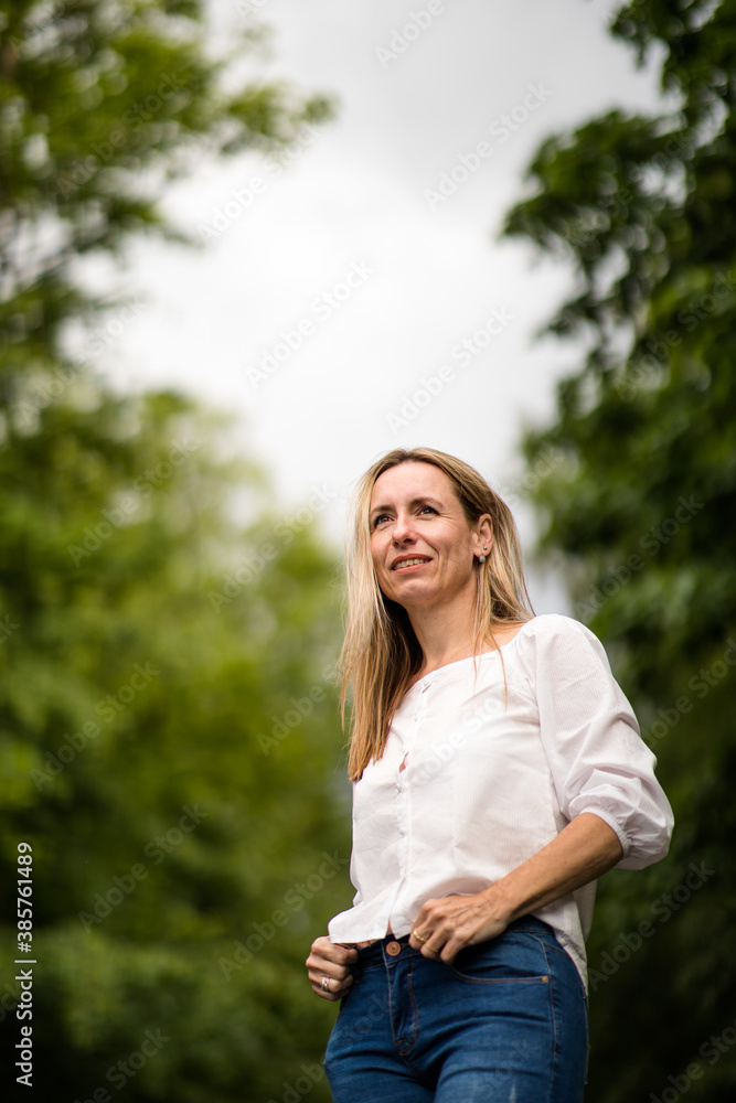 Portrait of a relaxed middle aged woman outdoors, looking happy, enjoying the life Portrait of a relaxed middle aged woman outdoors, looking happy, enjoying the life