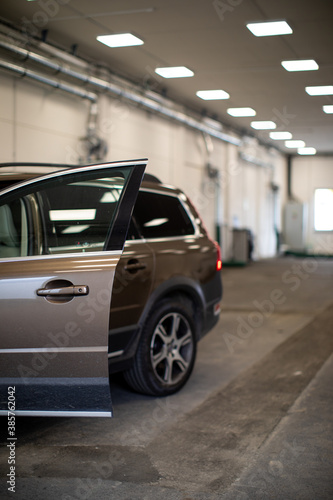 Car in a modern garage being worked on (shallow DOF/color toned image)