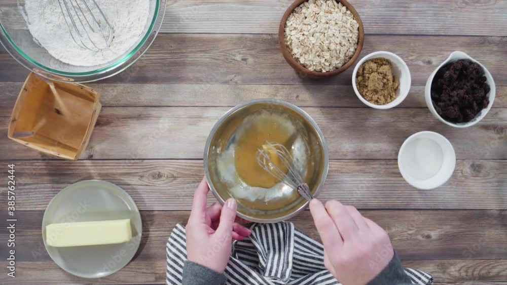 Flat lay. Step by step. Mixing ingredients to bake oatmeal raising cookies in a glass mixing bowl. Flat lay. Step by step. Mixing ingredients to bake oatmeal raising cookies in a glass mixing bowl.