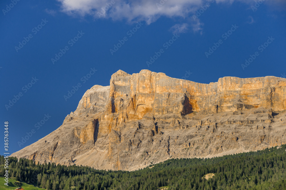 Fototapeta premium Late afternoon deep color view of Sasso di Santa Croce mountain range west wall and Mount Cavallo from La Villa village in Val Badia (valley), Eastern Dolomites, Alta Badia, South Tirol, Italy.