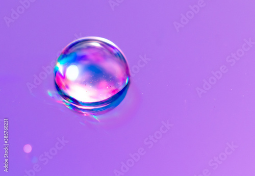 Blue drops of water on a pink background.