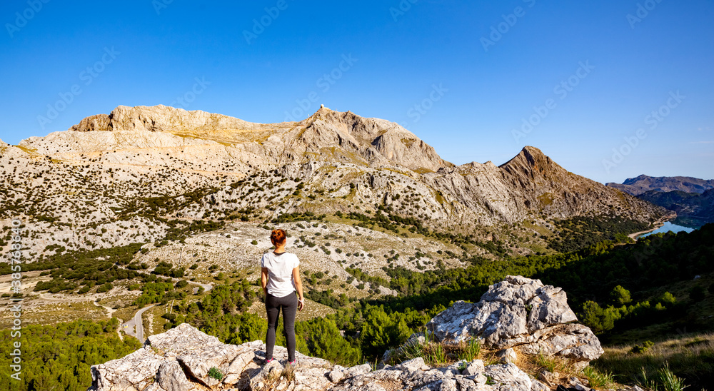 woman stand on view to mountains
