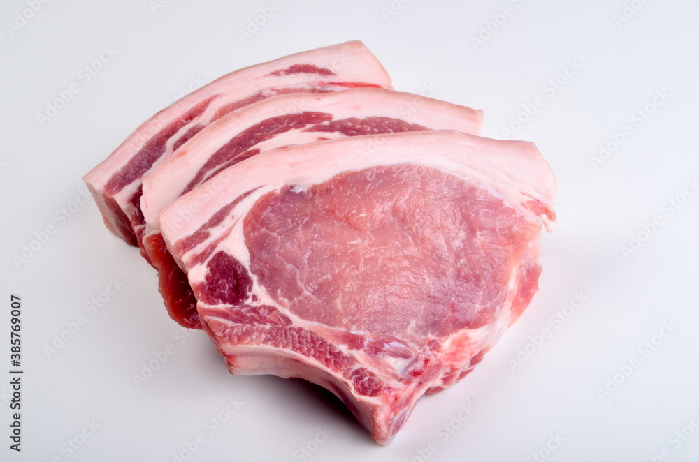 Sliced raw pork steak isolated on white background. Top view Sliced raw pork steak isolated on white background. Top view
