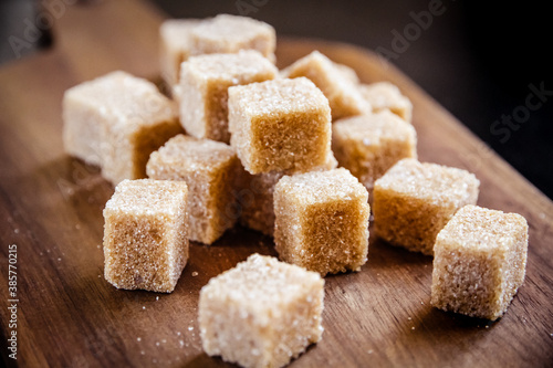 Brown cane sugar cubes on a cutting board
