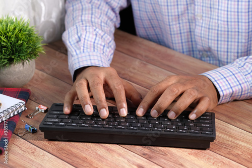 Close up of man hand typing on keyboard  photo