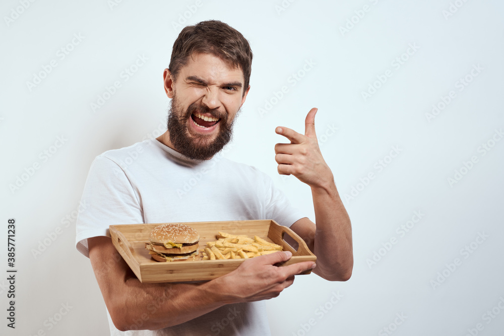 man with wooden tray fries and hamburger fast food calories model white t-shirt man with wooden tray fries and hamburger fast food calories model white t-shirt