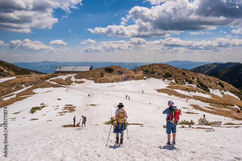 Fototapeta Naklejka Na Ścianę i Meble -  Views from Dumbier Mountain in Low Tatras mountains. Late spring, snow-capped mountains. Tourism and hiking NAPANT National Park travel destination