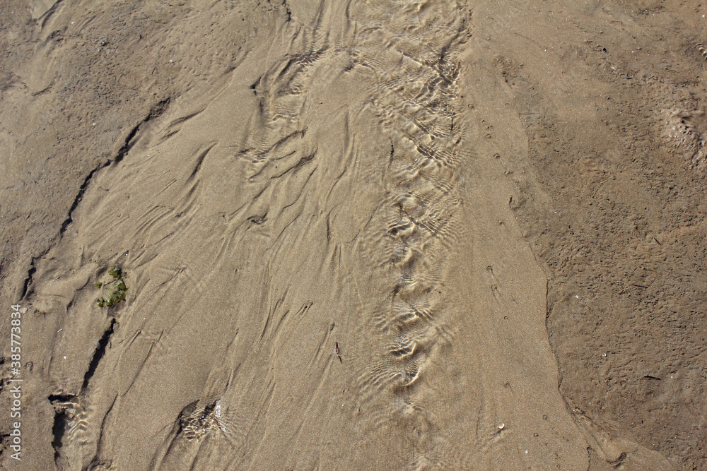 Texture water streak on sand the beach - South Sea of Korea Texture water streak on sand the beach - South Sea of Korea