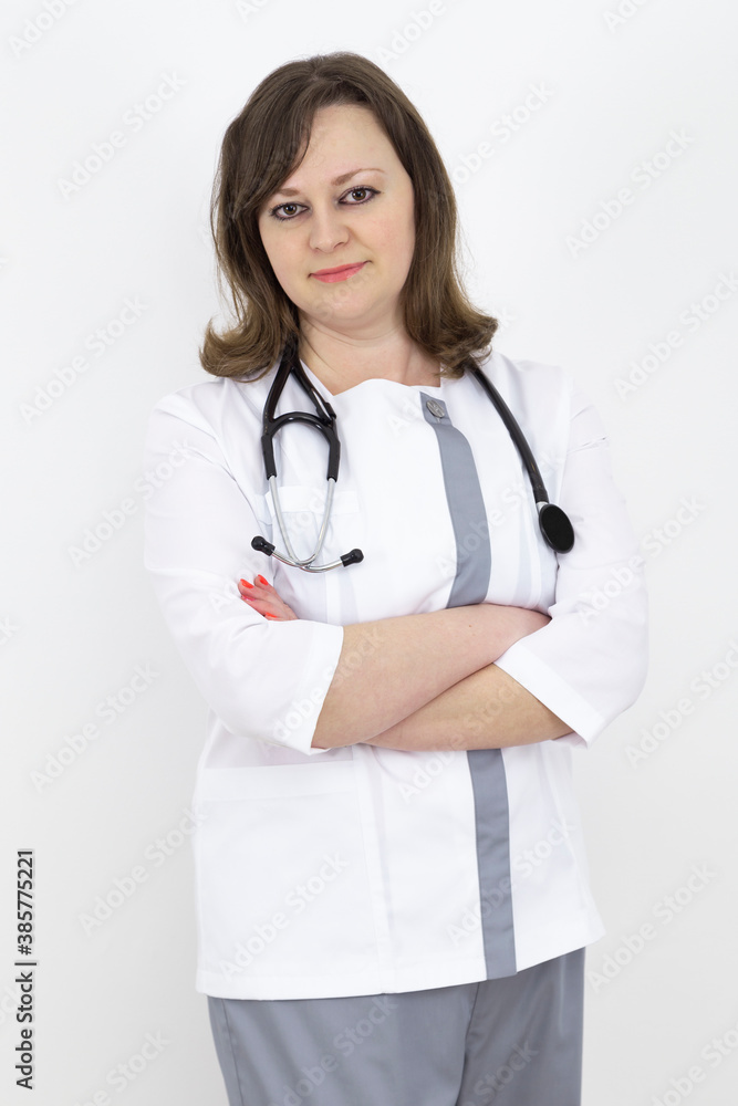 adult female doctor with a stethoscope against a white wall. adult female doctor with a stethoscope against a white wall.