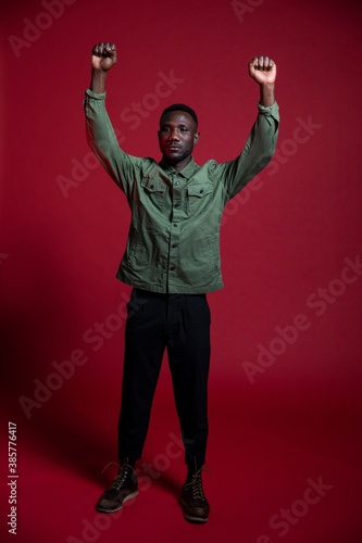 Black Man Raising Both Fists for Professional Studio Photoshoot