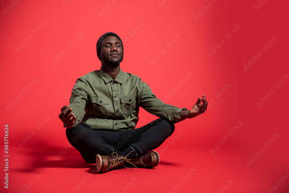 Young Black Man Meditating on Isolated Background Young Black Man Meditating on Isolated Background