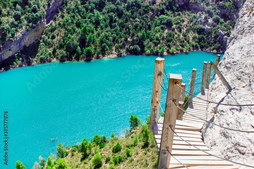 Landscape View On blue Lake In Mountain, green forest and wooden staircase, Congost De Mont Rebei, Lleida, Spain