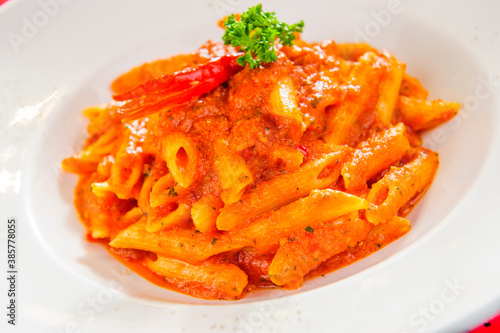 Plate of macaroni dish with tomato sauce