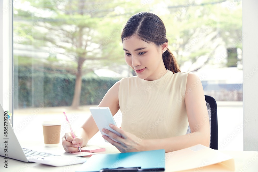 Beautiful businesswoman working in office with laptop Beautiful businesswoman working in office with laptop