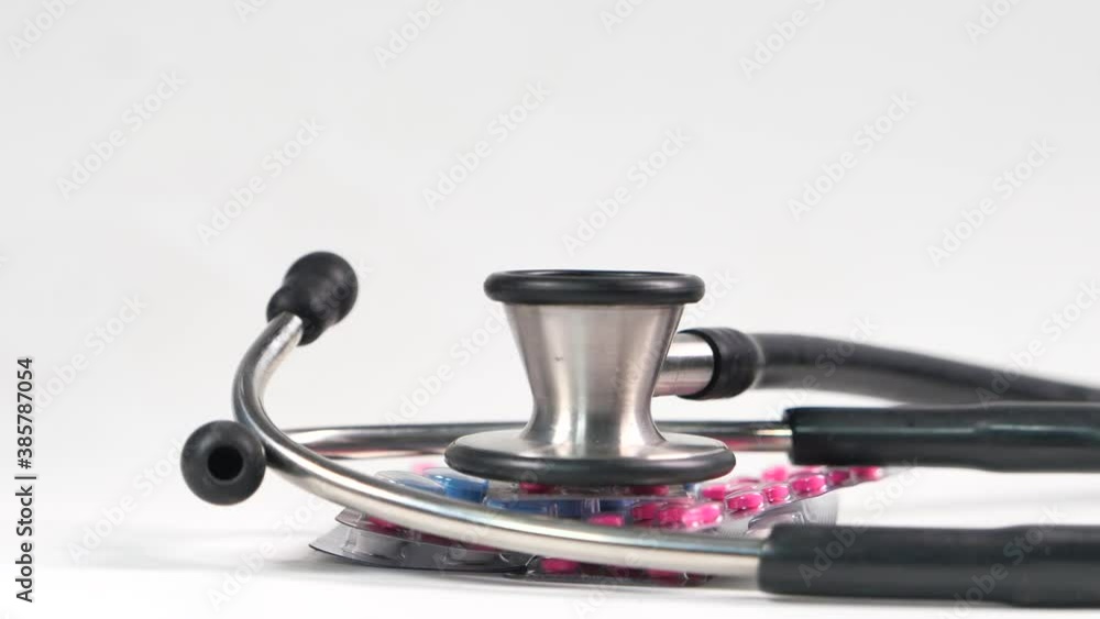 stethoscope and pills on white background stethoscope and pills on white background