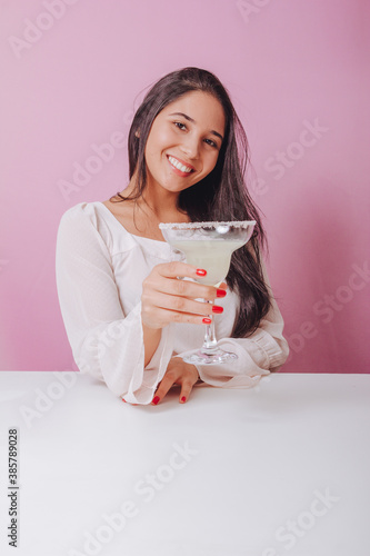 Young woman with margarita drink