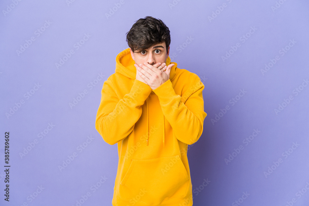 Young cool man shocked covering mouth with hands. Young cool man shocked covering mouth with hands.