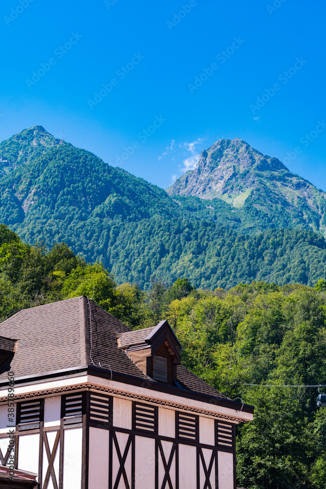 European house on the background of green mountains