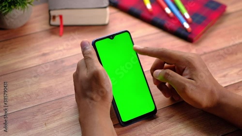 top view of man hand using smart phone on office desk  photo