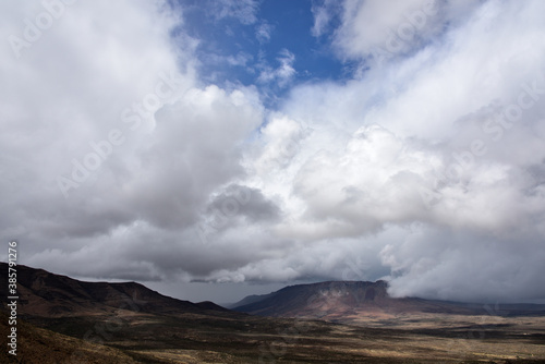 Thunder storm clouds building up in the arid semi-desert Karoo landscape in South Africa