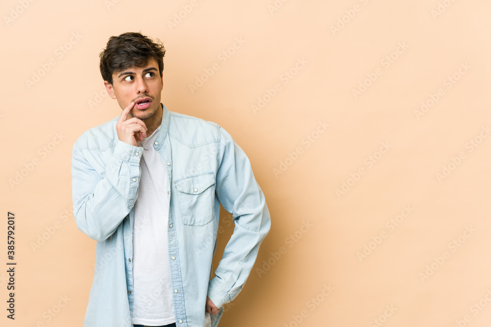 Young cool man looking sideways with doubtful and skeptical expression. Young cool man looking sideways with doubtful and skeptical expression.