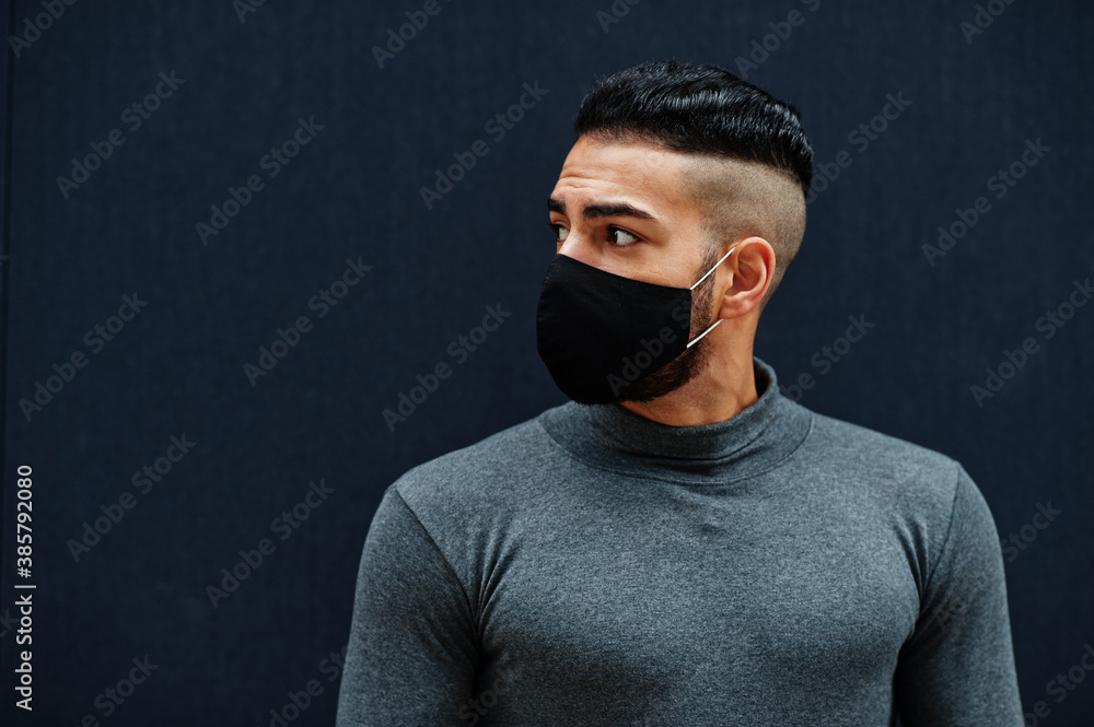 Middle eastern man in gray turtleneck and black face protect mask on isolated background. Middle eastern man in gray turtleneck and black face protect mask on isolated background.