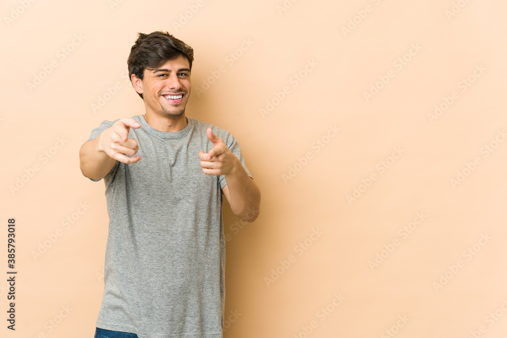 Young cool man cheerful smiles pointing to front. Young cool man cheerful smiles pointing to front.