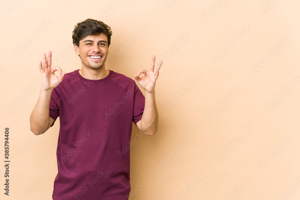 Young cool man cheerful and confident showing ok gesture. Young cool man cheerful and confident showing ok gesture.