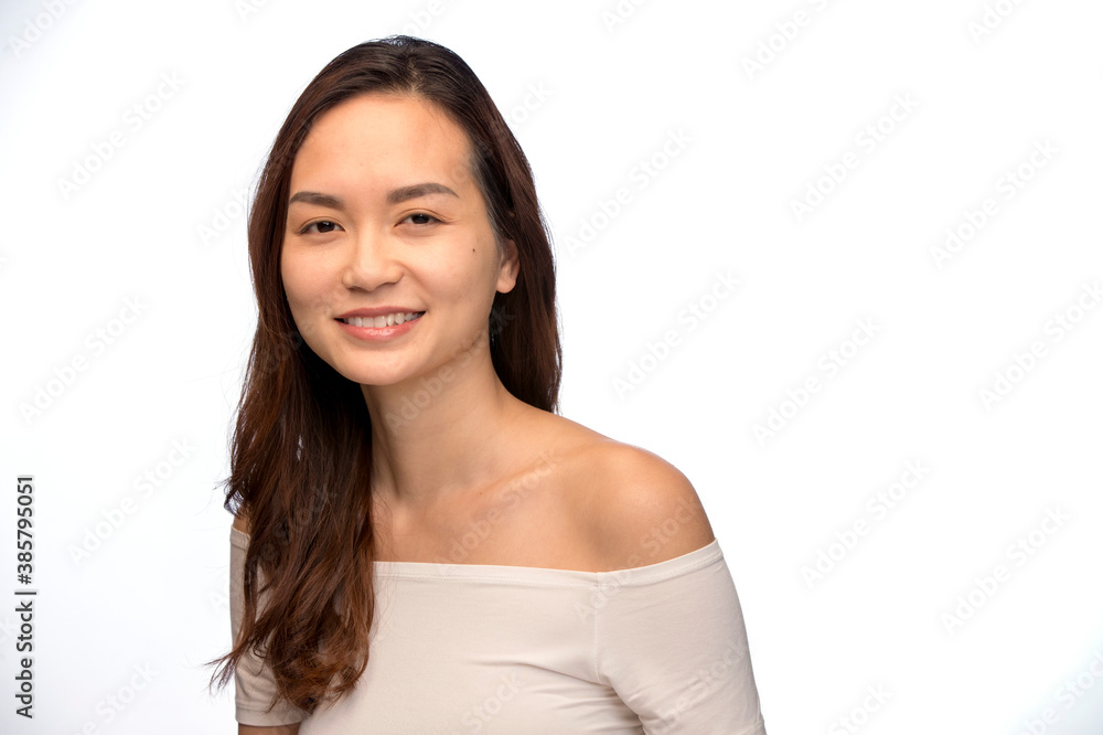Portrait of young woman of Asian descent looking at camera smiling Portrait of young woman of Asian descent looking at camera smiling