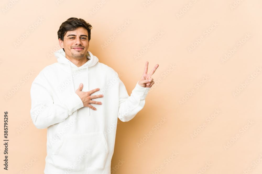 Young cool man taking an oath, putting hand on chest.