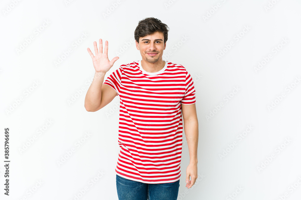 Young cool man smiling cheerful showing number five with fingers. Young cool man smiling cheerful showing number five with fingers.